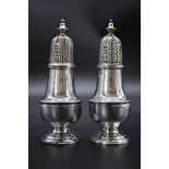 A pair of George III silver sugar casters, by C.H., London 1777, 16cm, 357g.