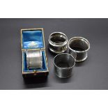 Four various silver napkin rings, one cased, 114g.