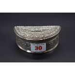 An antique Laos or Burmese white metal betel nut or lime box, of semi-circular form, 9.5cm.