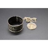 A silver napkin ring, together with a silver St Christopher medallion, on chain stamped .925.