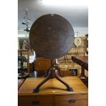 A George III mahogany and ash circular tilt-top tripod table, 60cm diameter.