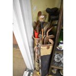 A collection of twenty-five old golf clubs, in three bags.