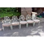 A set of five green painted dining chairs.