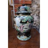 A Chinese famille rose black ground jar and cover, 39cm high, (a.f.).