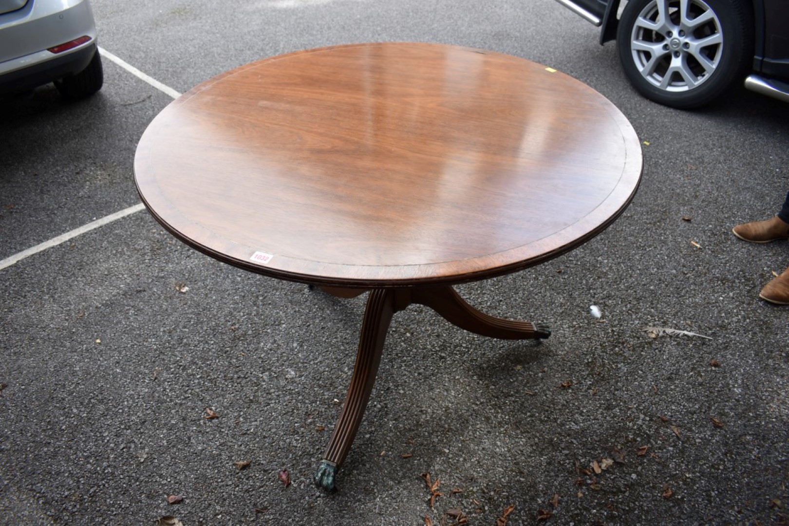 A reproduction mahogany and brass strung circular table, 100cm diameter.