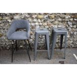 A grey upholstered bar stool; together with two other metal bar stools.