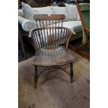 A 19th century yew, elm and fruitwood comb back Windsor armchair.