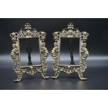 A pair of cast brass easel back photograph frames, in the Renaissance style, apertures 13.5 x 10cm.