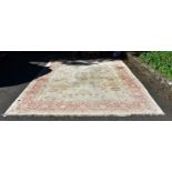 A large machine made carpet, having allover floral decoration on a beige ground, 372 x 277cm.