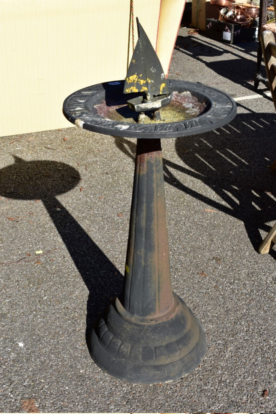 A cast iron sundial and bird bath.