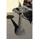 A cast iron sundial and bird bath.