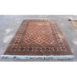 A Bokhara rug, having repeated decoration to central field on an orange ground, 290 x 203cm.