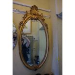 A reproduction giltwood framed oval wall mirror, 92 x 43.5cm.