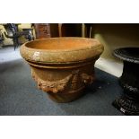 A large old terracotta garden pot, decorated with classical swags, 49cm high x 65cm diameter.