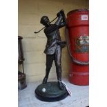 A patinated metal figure of a golfer, 36cm high.