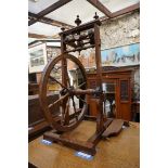 An old walnut spinning wheel, 83cm high.