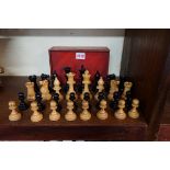 A boxwood and ebonized Staunton pattern chess set, king 9.4cm, pawn 4.9cm, in stained wood box.