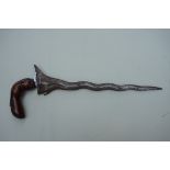 An Indonesian kris, possibly Sumatran, with 32cm wavy blade and well patinated hilt.