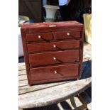 A small stained wood five drawer chest, 33cm wide x 36cm high.