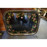 A large 19th century toleware tray, 77.5cm wide.