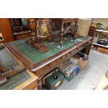 A late Victorian oak partner's desk, with three frieze drawers to each opposing side, on