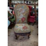 A Victorian carved walnut and gros point upholstered nursing type chair.