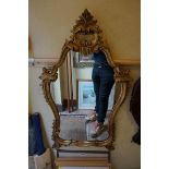 A reproduction giltwood framed wall mirror, 86 x 50.5cm.