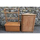 A pine hanging corner cupboard; together with a pine towel airer and a pine coffer.