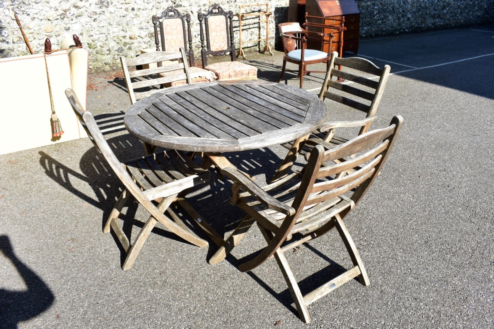 A teak garden table and four chairs by Alexander Rose.