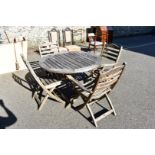 A teak garden table and four chairs by Alexander Rose.