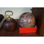 A brass mounted hardwood doorstop, 17cm high; together with a marble sphere, 15cm diameter. (2)