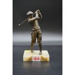 A bronzed spelter figure of a golfer, on onyx base, 19.5cm high.