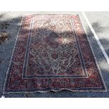 A Persian rug, having floral medallions with allover floral central field, 176 x 125cm.