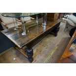 An old carved oak refectory type table, with cup and cover supports, 212.5cm long.