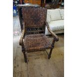 A 17th century style walnut and woven leather open arm elbow chair.