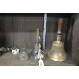 Four various hand bells.