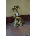 An antique cast brass dolphin doorstop, 35cm high; together with a small brass spark guard, 58cm