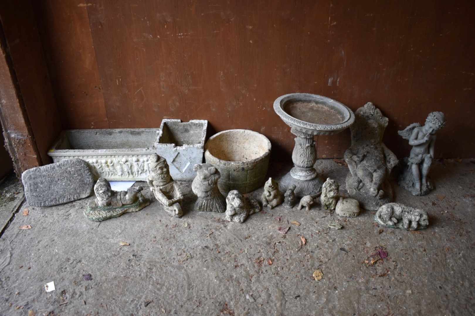 A reconstituted stone planter; together with other garden statuary.