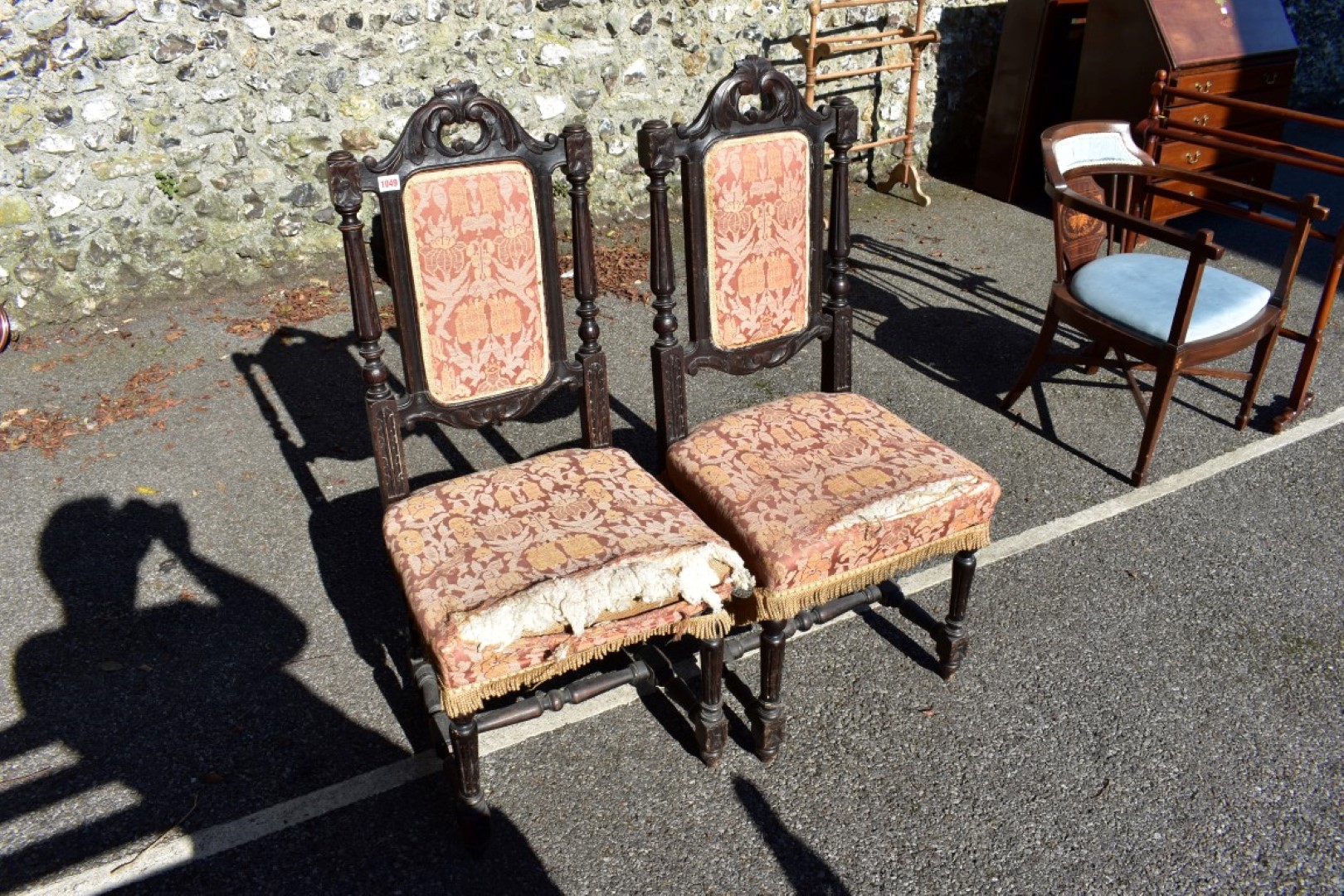 A pair of antique carved oak hall chairs, 110cm high.