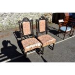 A pair of antique carved oak hall chairs, 110cm high.