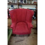 A Victorian walnut wing armchair.