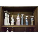 Four Lladro nuns, largest 33cm; together with another Lladro figure; and a Nao figure. (6)