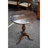 An antique oak tripod table, 53cm wide x 73cm high.