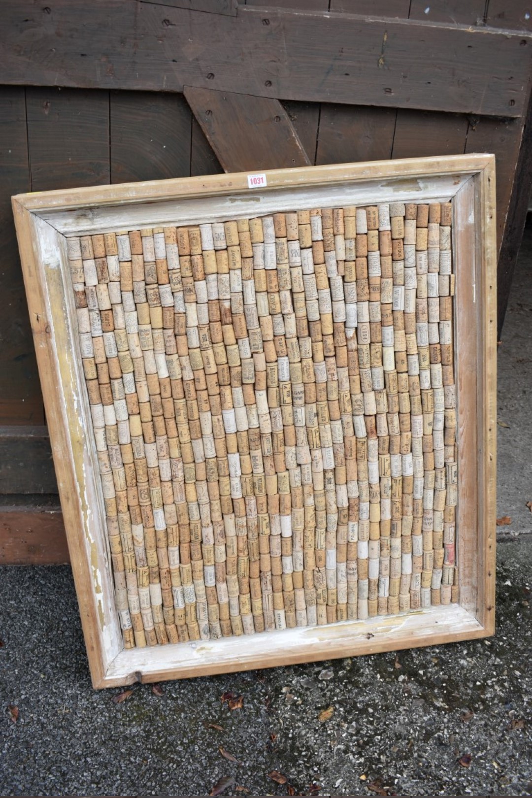 A framed display of bottle corks, 100cm wide x 84cm high.