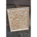 A framed display of bottle corks, 100cm wide x 84cm high.