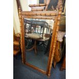 A large pitch pine and beech wall mirror, with simulated bamboo decoration, 158 x 88cm.