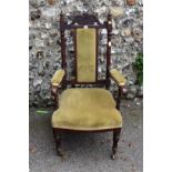 A Victorian rosewood and green upholstered armchair.