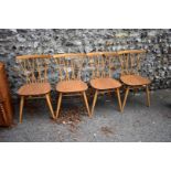 A set of four vintage blonde Ercol candlestick chairs.