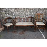 A near matching Edwardian inlaid suite; comprising settee, corner chair and elbow chair.