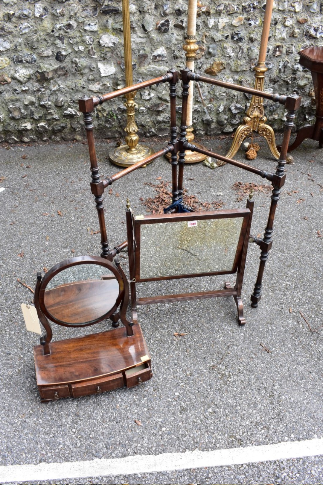 Two antique mahogany toilet mirrors; together with a towel airer.